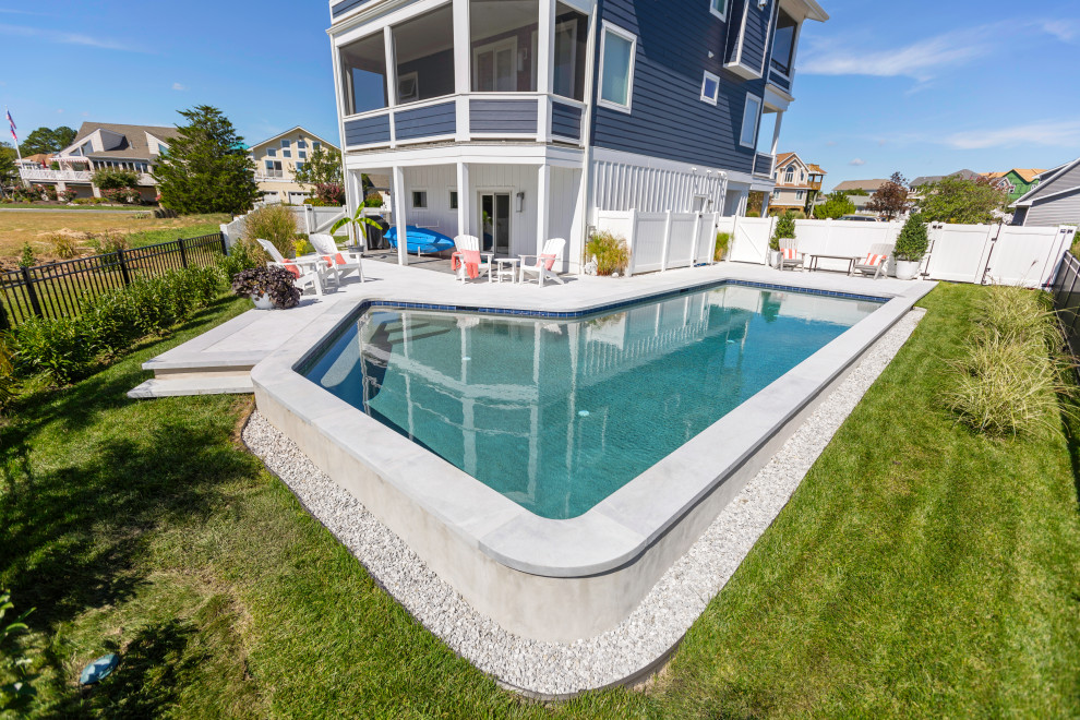 Inspiration for a medium sized nautical side custom shaped swimming pool in Other with natural stone paving.
