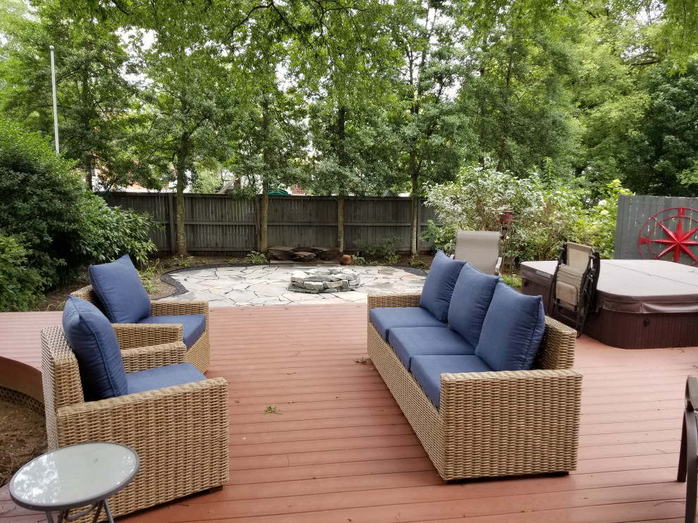 Inspiration for a mid-sized transitional backyard stone deck remodel in Baltimore with a fire pit and no cover