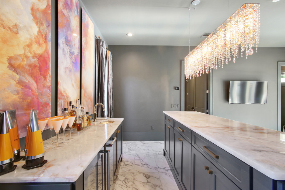 Inspiration for a mid-sized transitional galley wet bar in New Orleans with an undermount sink, shaker cabinets, grey cabinets, marble benchtops, marble floors, white floor and white benchtop.