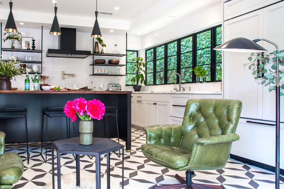 Large transitional eat-in kitchen in Los Angeles with a single-bowl sink, shaker cabinets, grey cabinets, marble benchtops, white splashback, ceramic splashback, black appliances, cement tiles, with island and black floor.