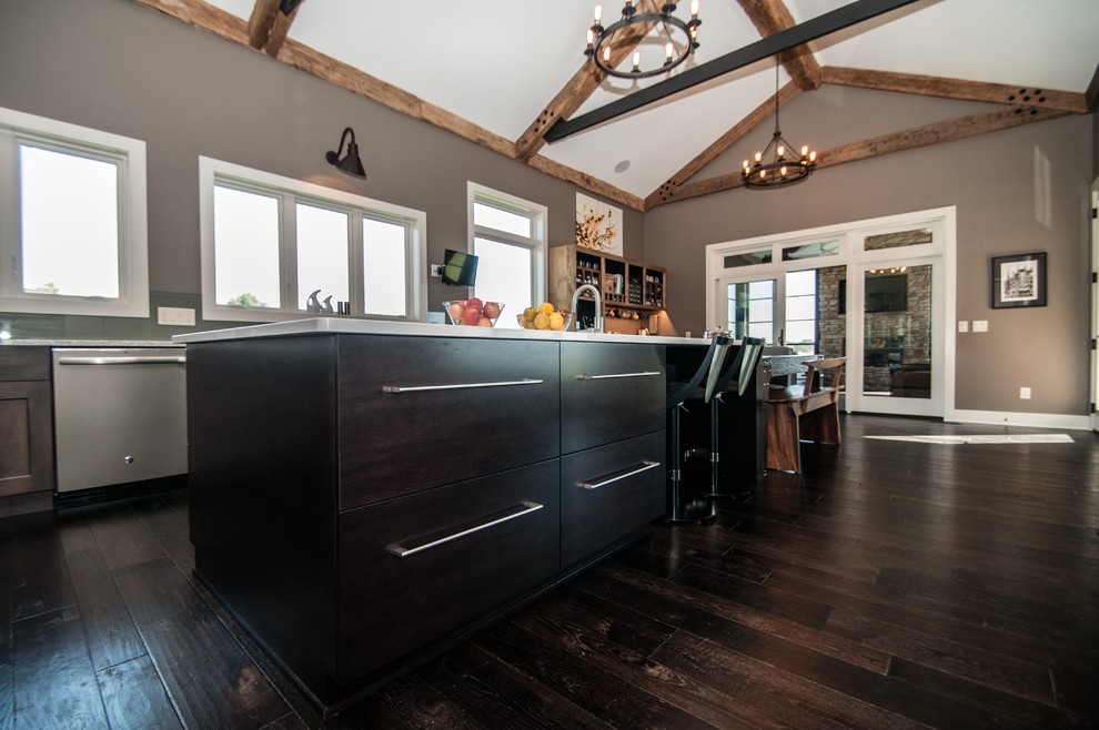 Eat-in kitchen - large rustic dark wood floor and brown floor eat-in kitchen idea with an undermount sink, flat-panel cabinets, medium tone wood cabinets, quartz countertops, green backsplash, glass sheet backsplash, stainless steel appliances and an island