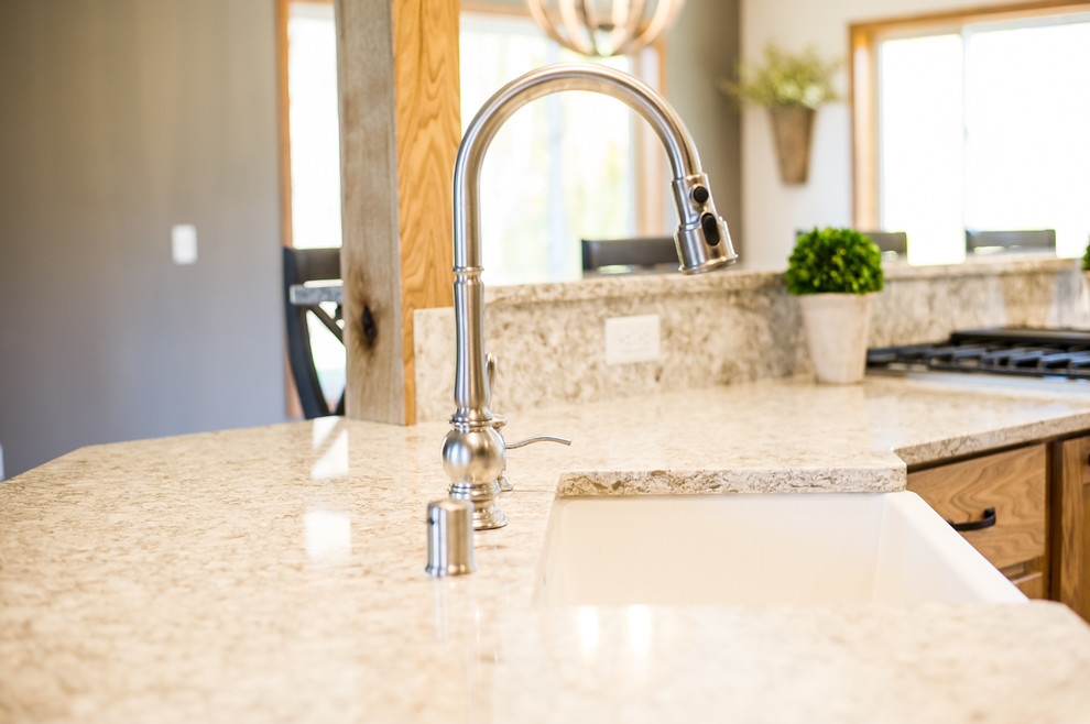 Large mountain style u-shaped medium tone wood floor open concept kitchen photo with a farmhouse sink, recessed-panel cabinets, purple cabinets, beige backsplash, stainless steel appliances, an island and granite countertops