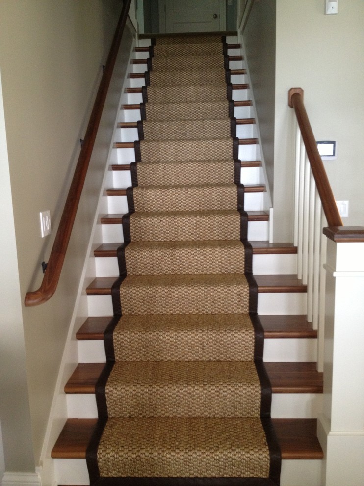 Photo of a mid-sized transitional wood straight staircase in Chicago with wood risers.