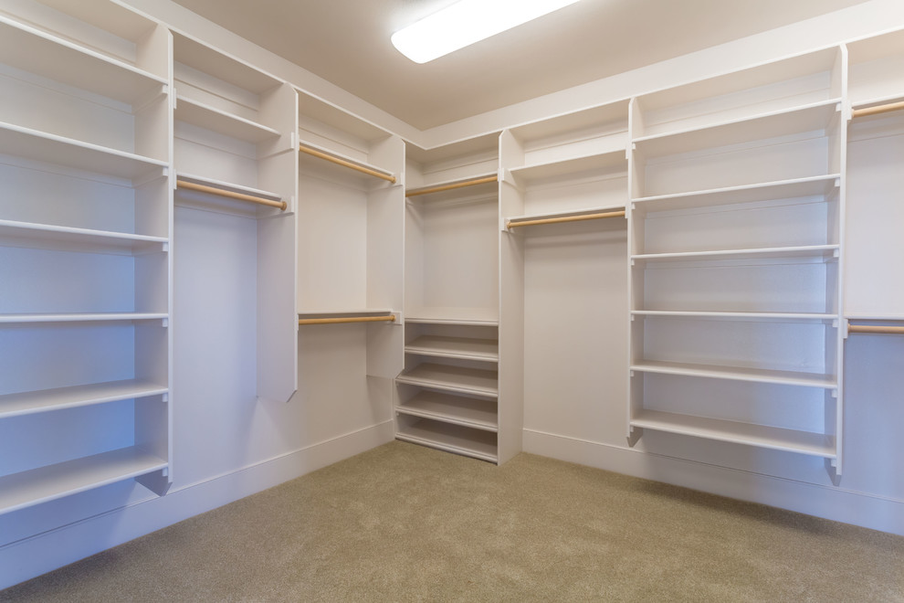 Design ideas for a large arts and crafts gender-neutral walk-in wardrobe in Portland with carpet.