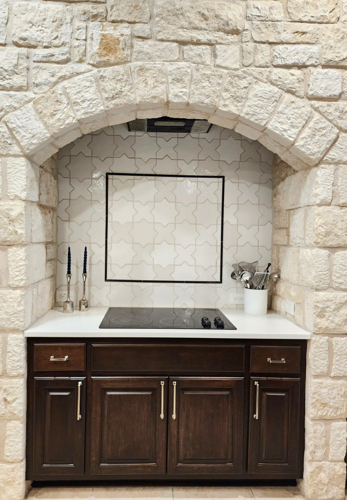 Inspiration for a mid-sized transitional l-shaped ceramic tile and beige floor open concept kitchen remodel in Austin with a single-bowl sink, raised-panel cabinets, dark wood cabinets, quartz countertops, white backsplash, ceramic backsplash, stainless steel appliances, two islands and white countertops