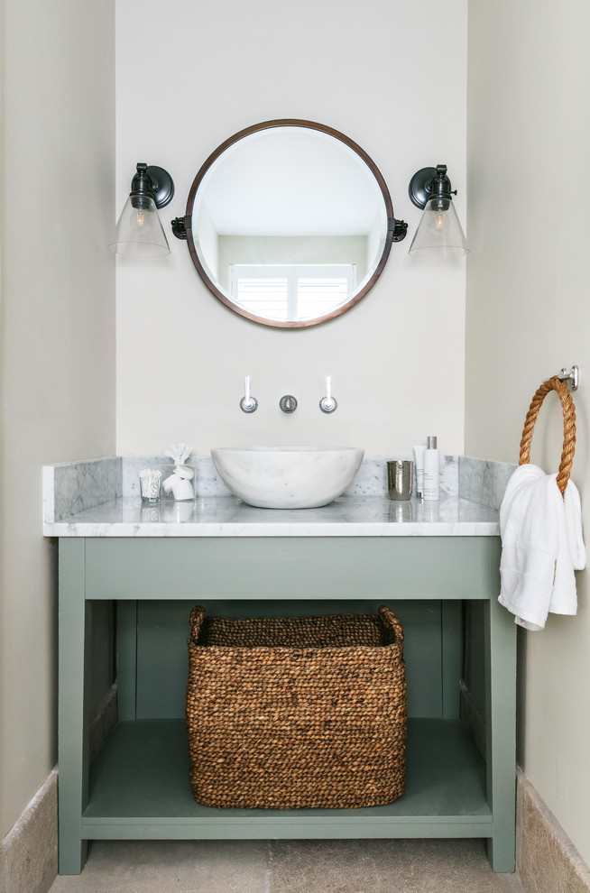 Design ideas for an expansive nautical cloakroom in London with freestanding cabinets, green cabinets, a vessel sink and grey floors.