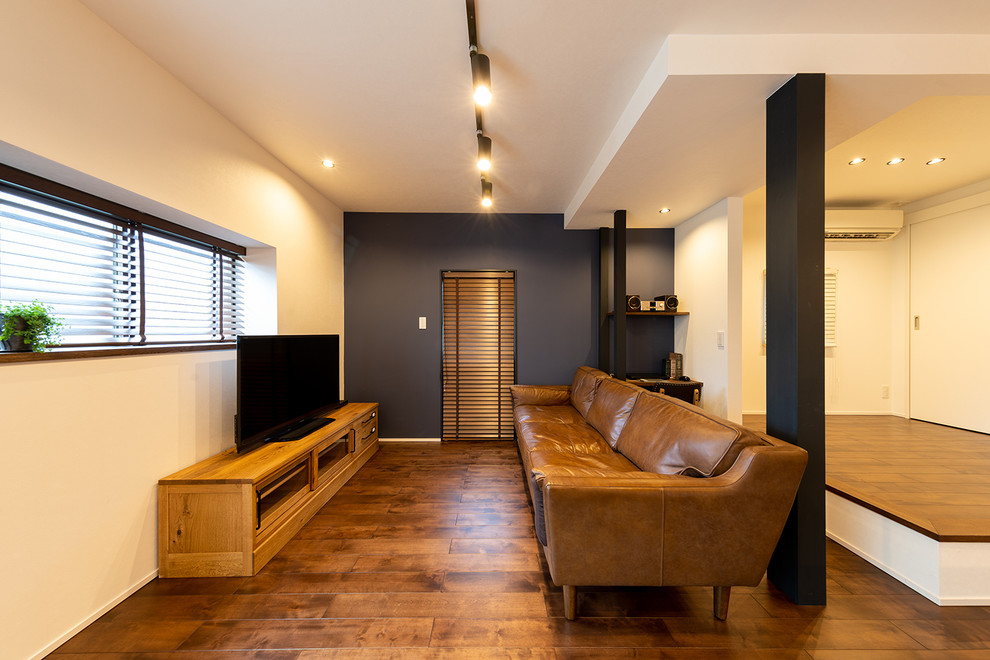 Photo of a midcentury living room in Other with multi-coloured walls, dark hardwood floors and brown floor.