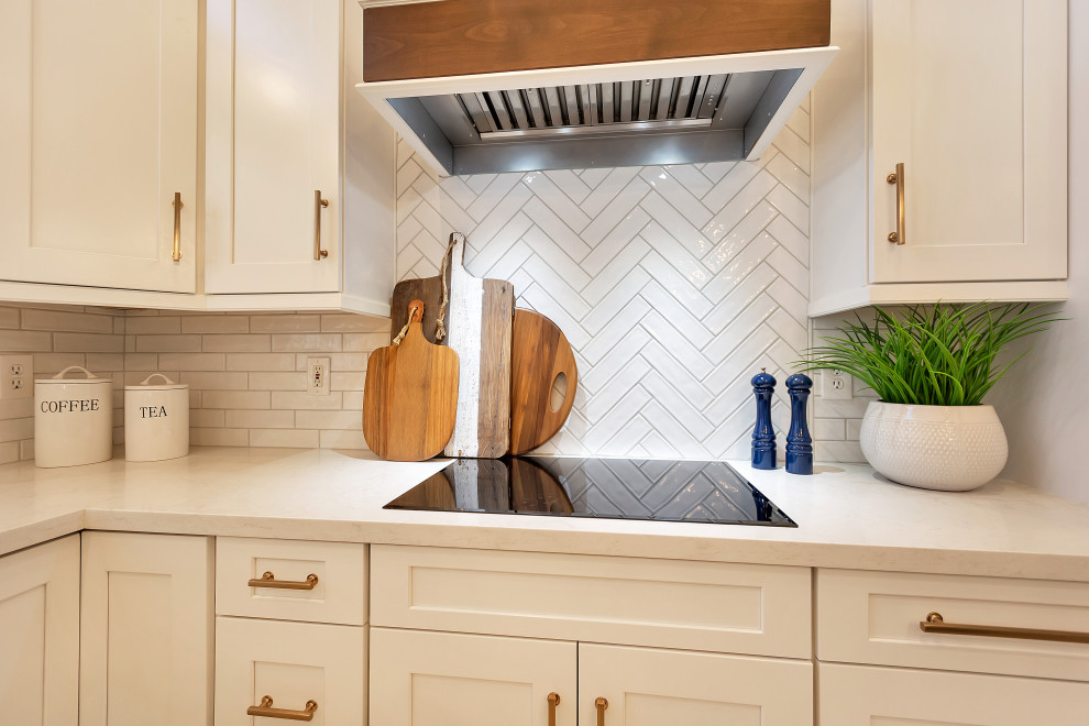 Inspiration for a large transitional u-shaped open concept kitchen remodel in Phoenix with a farmhouse sink, shaker cabinets, white cabinets, quartz countertops, white backsplash, subway tile backsplash, stainless steel appliances, an island and white countertops