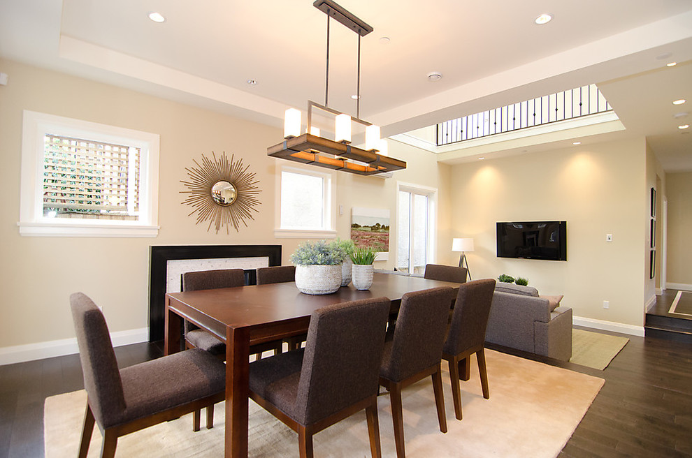 Inspiration for a contemporary dining room in Vancouver with beige walls and dark hardwood floors.