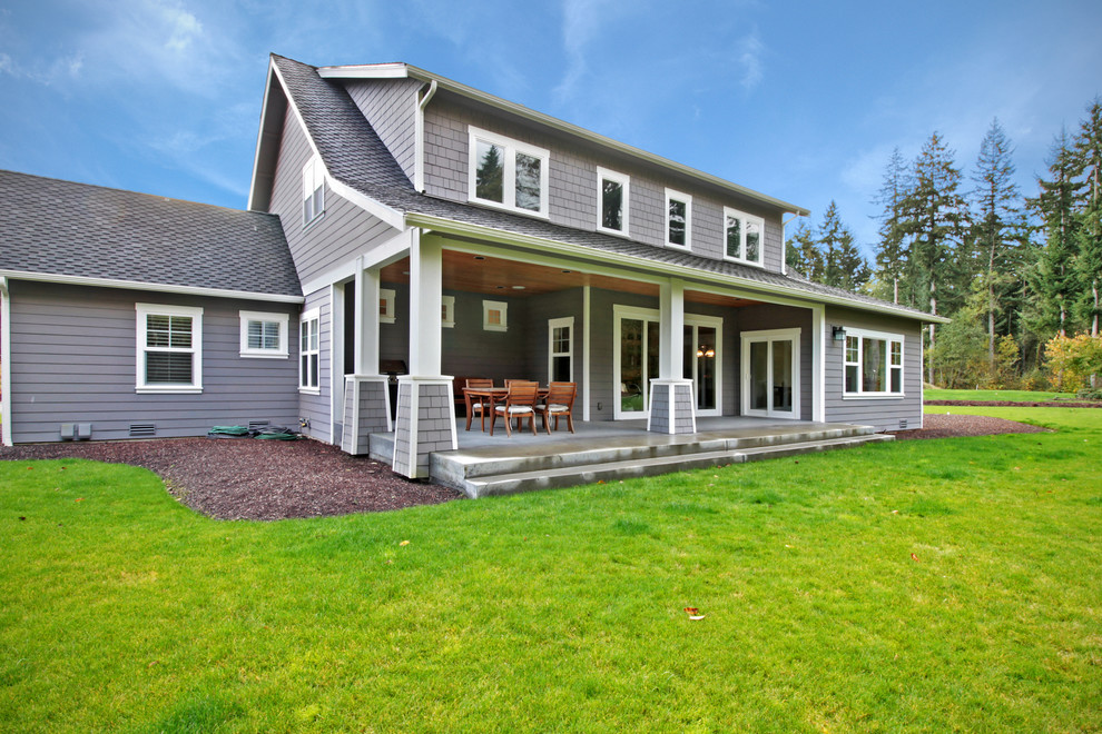 This is an example of an arts and crafts two-storey grey exterior in Seattle with a gable roof.