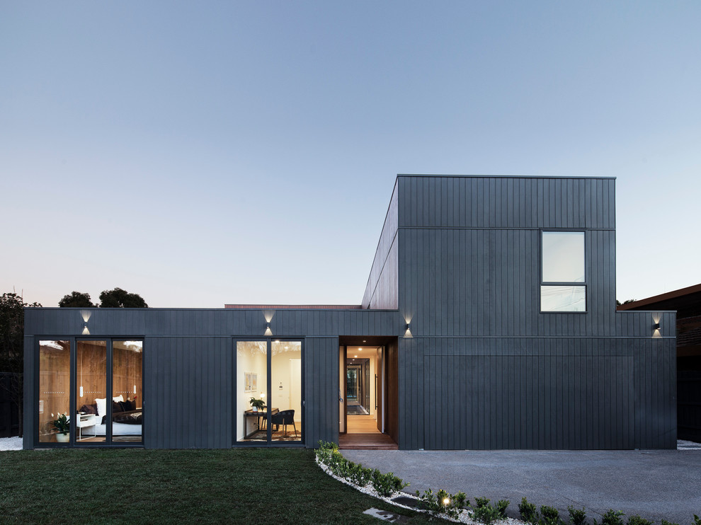 Design ideas for an expansive contemporary two-storey black exterior in Melbourne with wood siding and a flat roof.