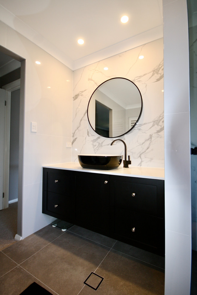Small transitional master bathroom in Sydney with shaker cabinets, black cabinets, white tile, marble, ceramic floors, engineered quartz benchtops, grey floor, white benchtops, a single vanity, a floating vanity and recessed.