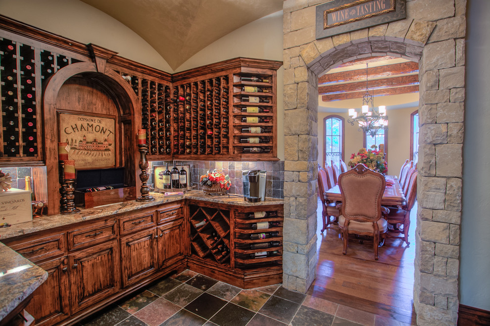 Design ideas for a large mediterranean wine cellar in Oklahoma City with storage racks and slate floors.