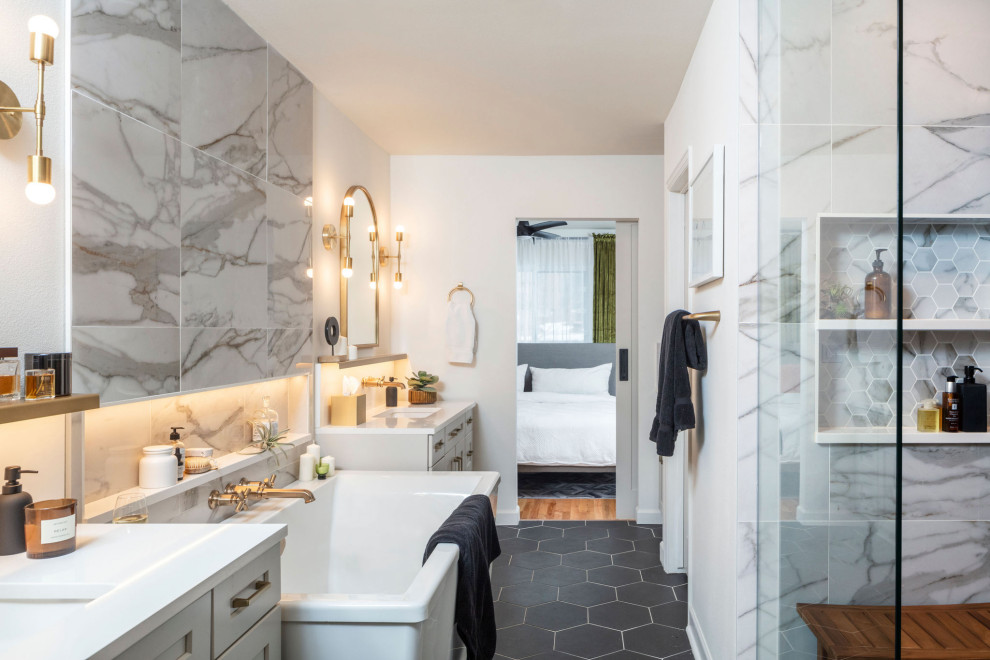 Стильный дизайн: большая главная ванная комната в стиле неоклассика (современная классика) с фасадами в стиле шейкер, серыми фасадами, отдельно стоящей ванной, душем в нише, унитазом-моноблоком, разноцветной плиткой, мраморной плиткой, белыми стенами, полом из керамической плитки, врезной раковиной, столешницей из искусственного кварца, черным полом, душем с распашными дверями, белой столешницей, нишей, тумбой под две раковины, напольной тумбой и многоуровневым потолком - последний тренд