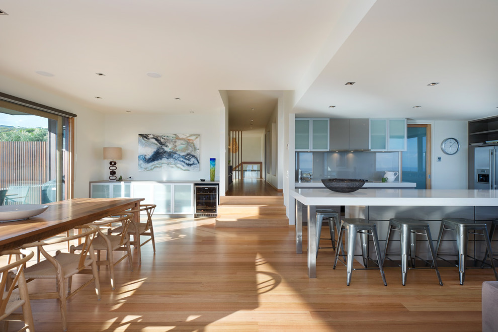 Inspiration for a modern open plan dining in Melbourne with white walls and medium hardwood floors.