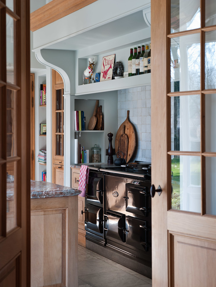 Inspiration for a traditional separate kitchen in Other with light wood cabinets, blue splashback and black appliances.