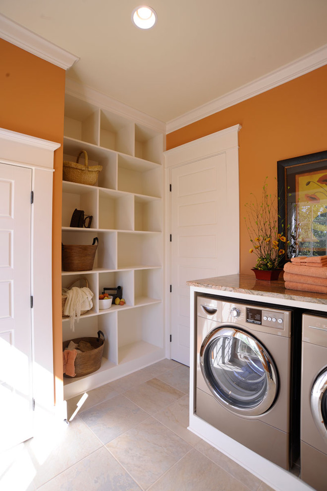 Photo of a traditional u-shaped utility room in Columbus with orange walls, shaker cabinets, white cabinets and a side-by-side washer and dryer.