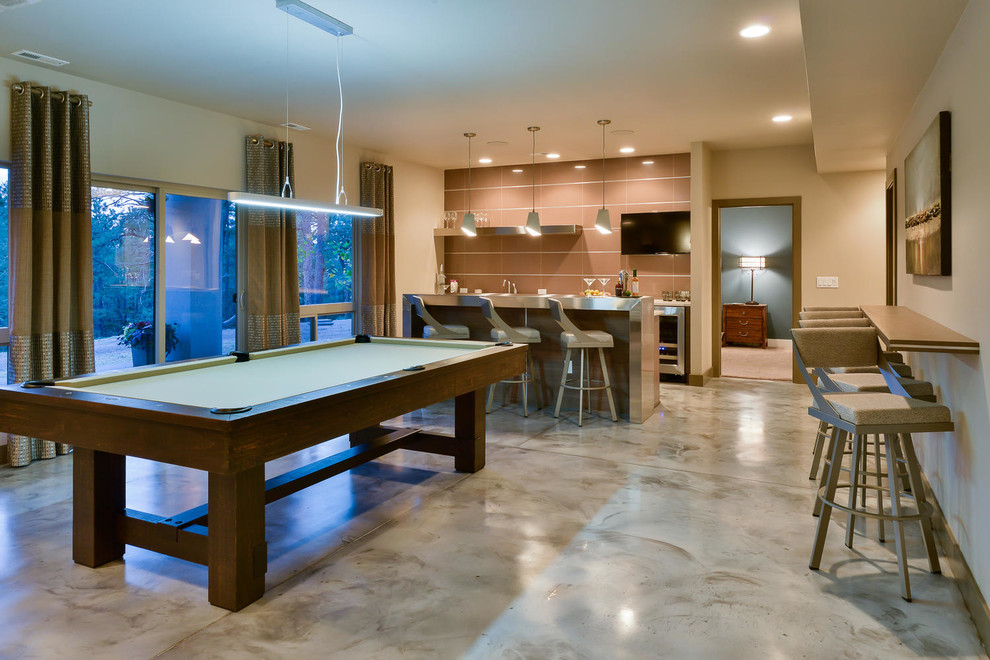 Inspiration for a large contemporary walk-out basement in Denver with beige walls, concrete floors, no fireplace, brown floor and a game room.