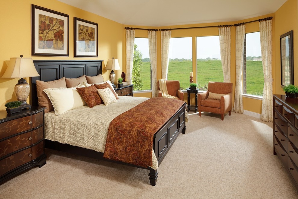 Design ideas for a mid-sized traditional guest bedroom in Charlotte with yellow walls, carpet and beige floor.