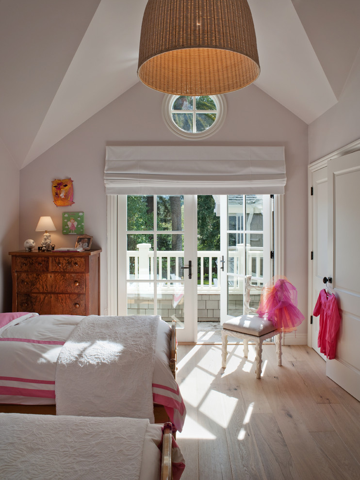 Photo of a traditional kids' bedroom for kids 4-10 years old and girls in San Francisco with grey walls and light hardwood floors.