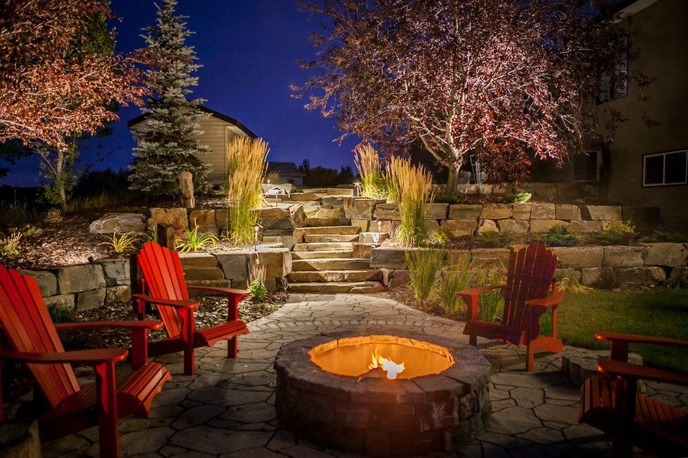 Design ideas for an expansive country backyard partial sun garden for summer in Calgary with a retaining wall and concrete pavers.