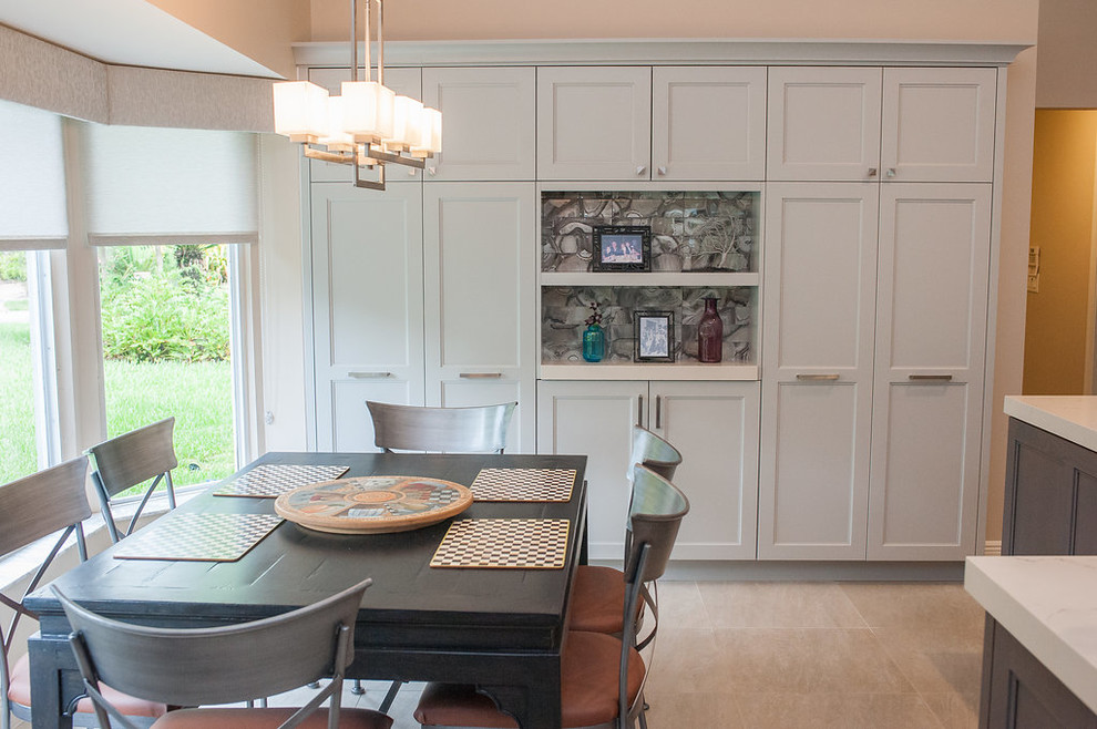 Inspiration for a mid-sized transitional u-shaped porcelain tile and beige floor eat-in kitchen remodel in Miami with an undermount sink, shaker cabinets, gray cabinets, quartz countertops, gray backsplash, glass tile backsplash, stainless steel appliances, an island and white countertops