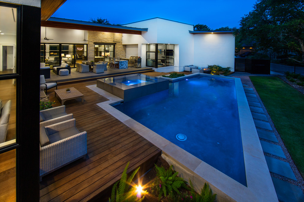 This is an example of a mid-sized contemporary backyard custom-shaped aboveground pool in Austin with decking.