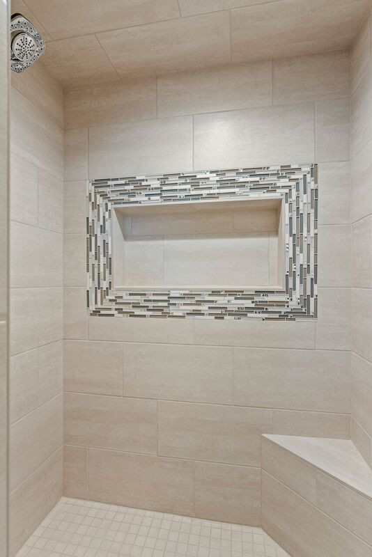 Inspiration for a transitional master ceramic tile alcove shower remodel with shaker cabinets, gray cabinets, an undermount sink, quartz countertops, a hinged shower door and white countertops