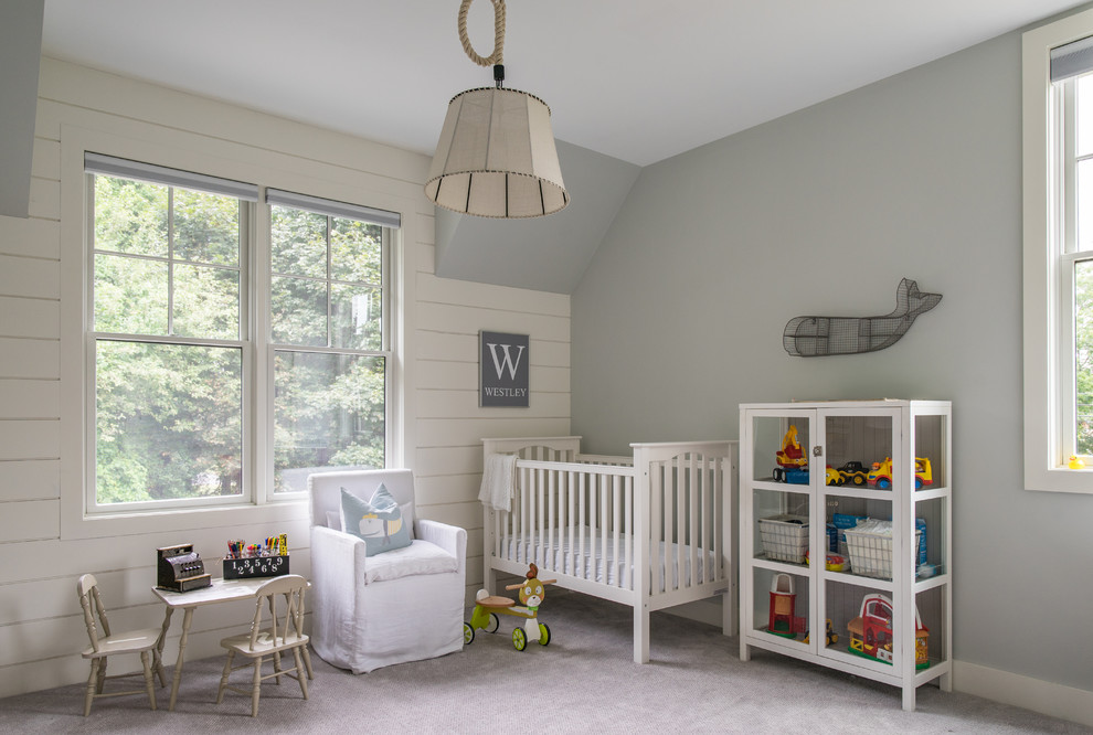 This is an example of a large country gender-neutral nursery in Boston with grey walls, carpet and grey floor.