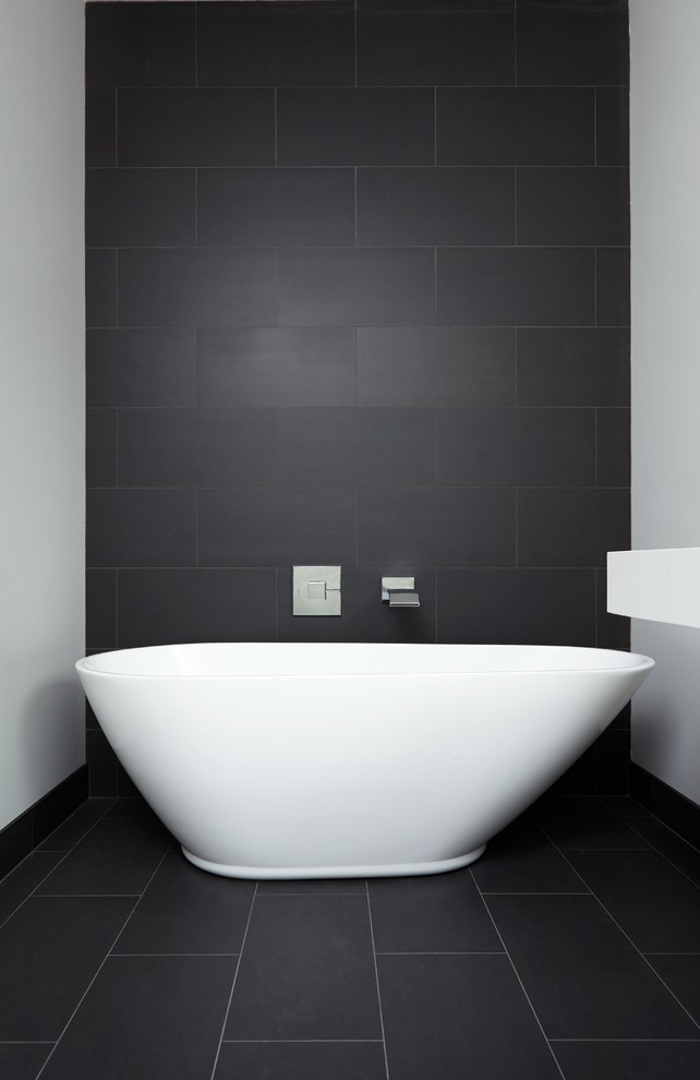 Design ideas for a large contemporary master bathroom in Toronto with a wall-mount sink, open cabinets, white cabinets, engineered quartz benchtops, a freestanding tub, a double shower, a one-piece toilet, black tile, porcelain tile, white walls and porcelain floors.