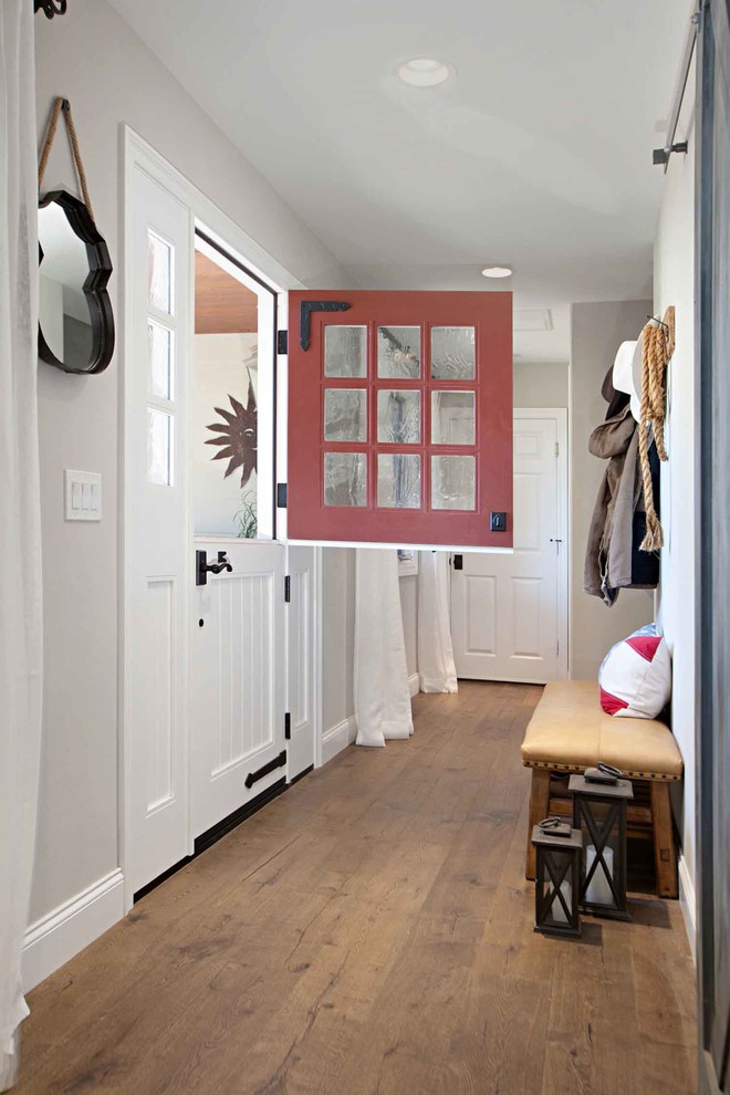 Inspiration for a country entryway in San Diego with grey walls, dark hardwood floors, a dutch front door and a red front door.