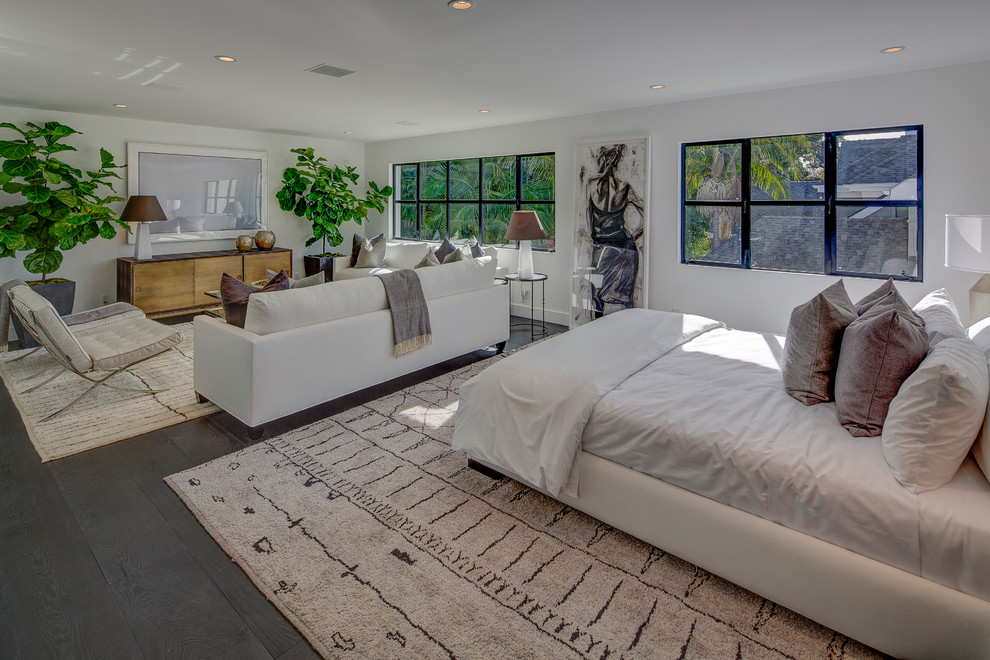 This is an example of a large contemporary guest bedroom in Los Angeles with white walls and dark hardwood floors.