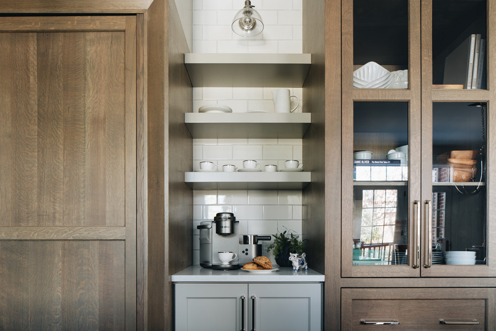 Inspiration for a mid-sized transitional dark wood floor eat-in kitchen remodel in Chicago with a farmhouse sink, shaker cabinets, gray cabinets, quartz countertops, white backsplash, ceramic backsplash, paneled appliances, an island and white countertops