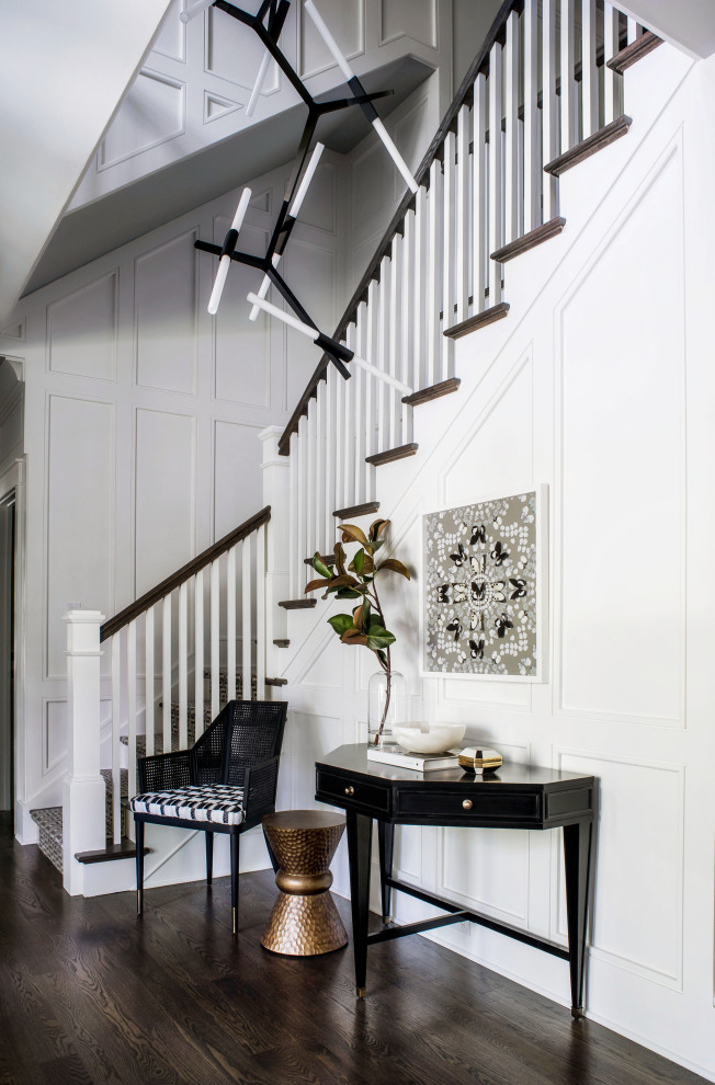 This is an example of a transitional foyer in Philadelphia with white walls, dark hardwood floors and brown floor.