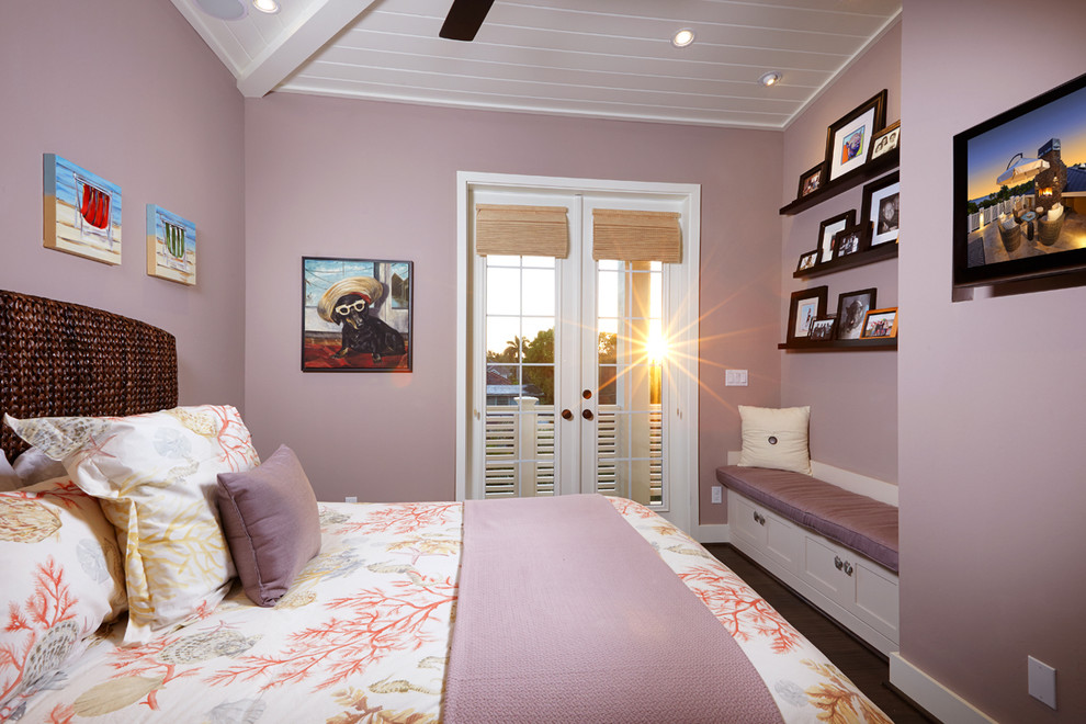 Photo of a small tropical bedroom in Miami with purple walls and dark hardwood floors.