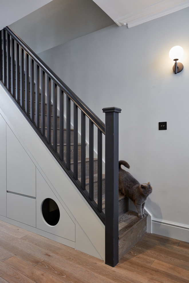 Medium sized contemporary wood railing staircase in London.