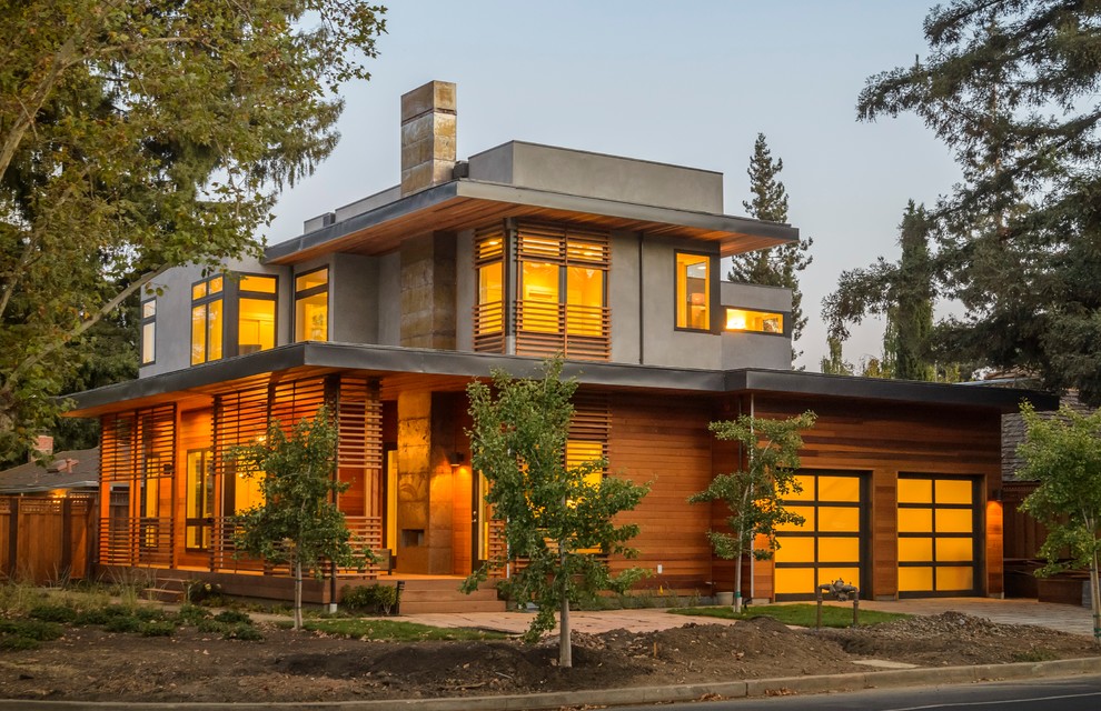 This is an example of a contemporary two-storey exterior in San Francisco with mixed siding and a flat roof.