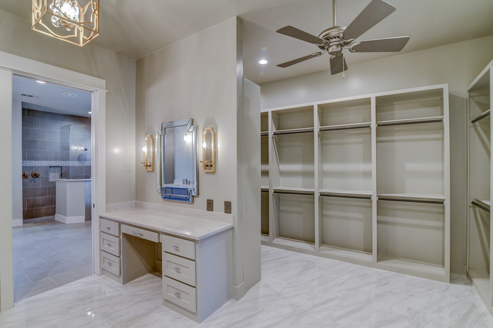 Photo of a large arts and crafts gender-neutral dressing room in Dallas with flat-panel cabinets, grey cabinets, ceramic floors and white floor.