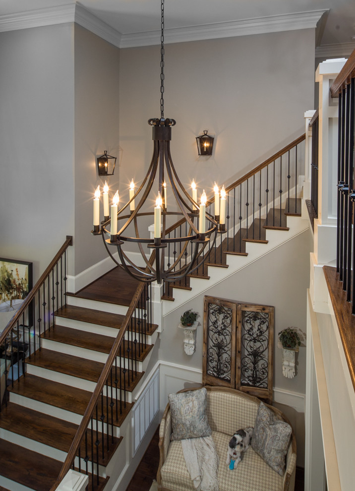 This is an example of a large transitional foyer in Other with grey walls, dark hardwood floors, a double front door and a dark wood front door.