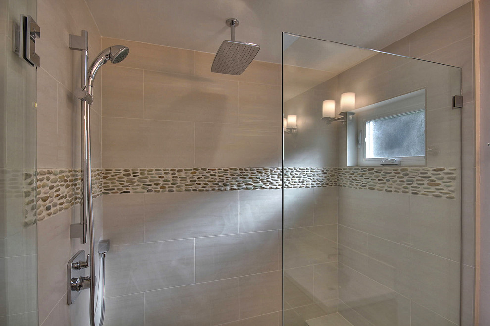 Photo of a transitional bathroom in San Francisco with an alcove shower, beige tile, porcelain tile and a hinged shower door.