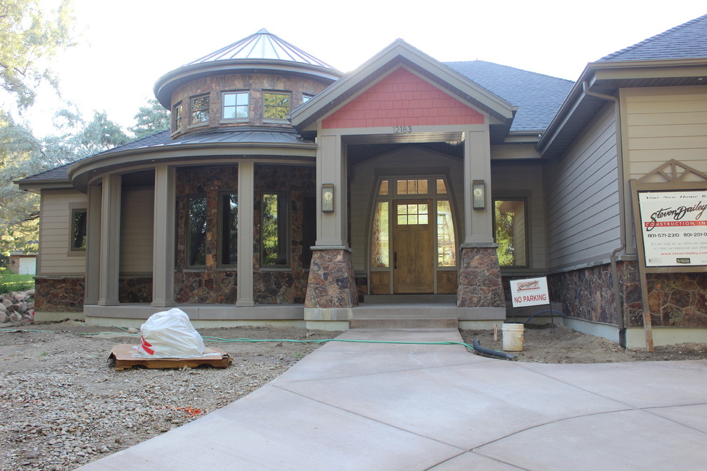 This is an example of a large traditional two-storey grey exterior in Salt Lake City with mixed siding.
