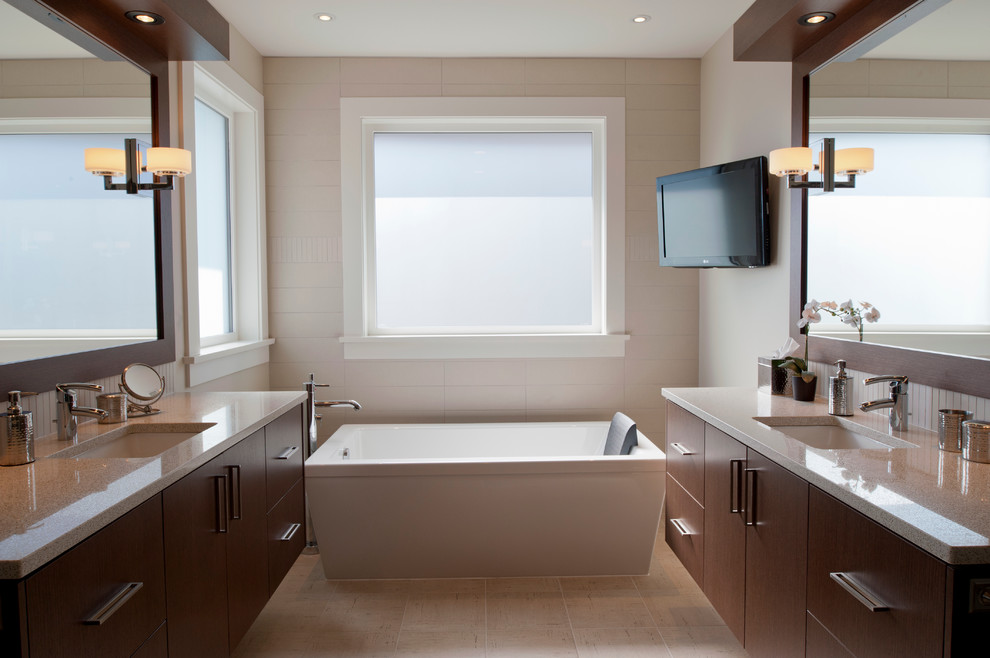 Contemporary bathroom in Vancouver with a freestanding tub and granite benchtops.