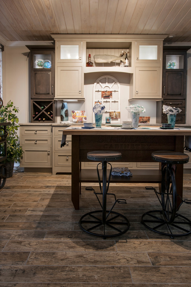 Mid-sized transitional single-wall ceramic tile and brown floor eat-in kitchen photo with beaded inset cabinets, beige cabinets, quartzite countertops, beige backsplash and an island