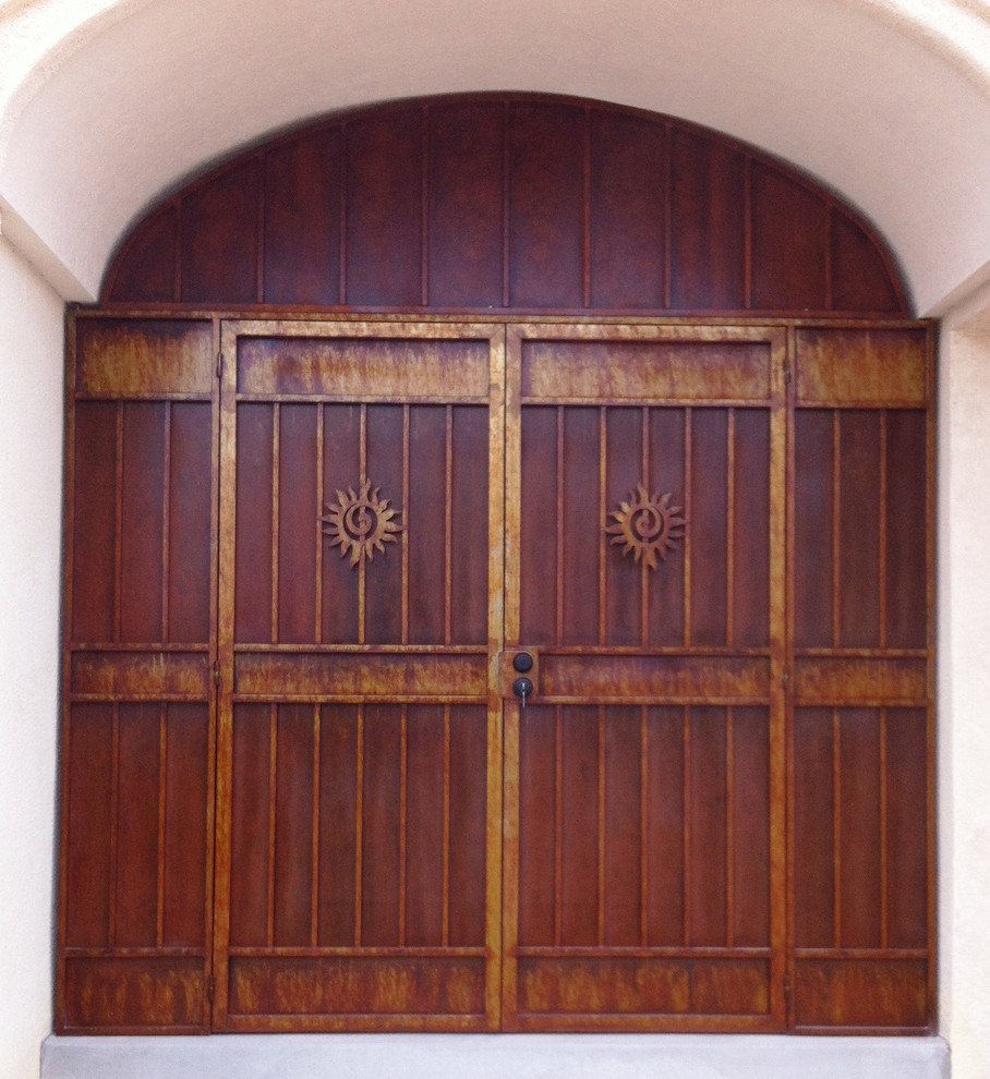 Front door - mid-sized rustic concrete floor front door idea in Albuquerque with beige walls and a metal front door
