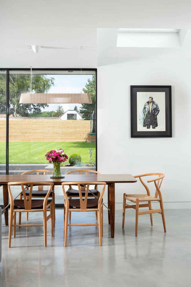 This is an example of a contemporary dining room in Hertfordshire.