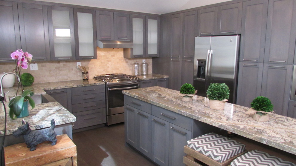 Transitional light wood floor kitchen photo with a farmhouse sink, gray cabinets, stainless steel appliances and an island