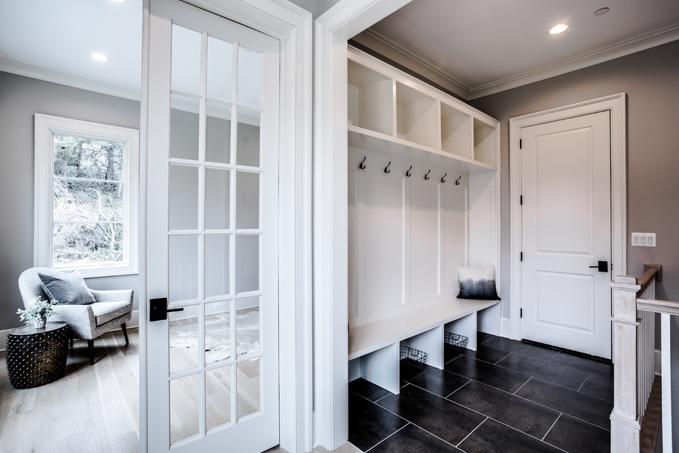 Large transitional ceramic tile and gray floor mudroom photo in DC Metro with gray walls and a white front door