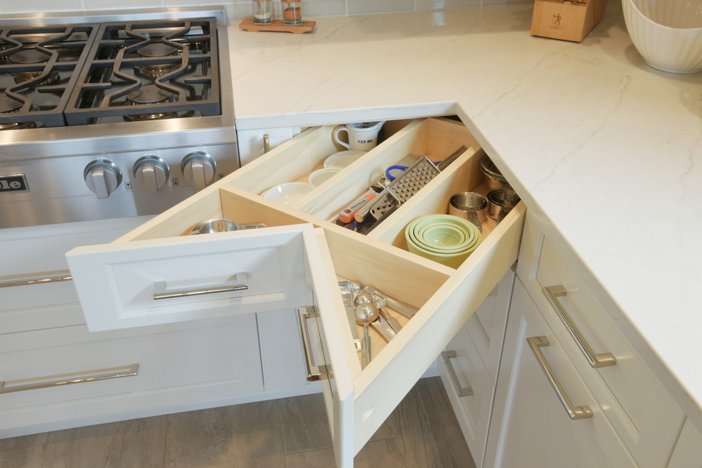 Inspiration for a transitional ceramic tile kitchen remodel in Seattle with shaker cabinets, white cabinets, quartzite countertops, subway tile backsplash, stainless steel appliances, an island and white countertops