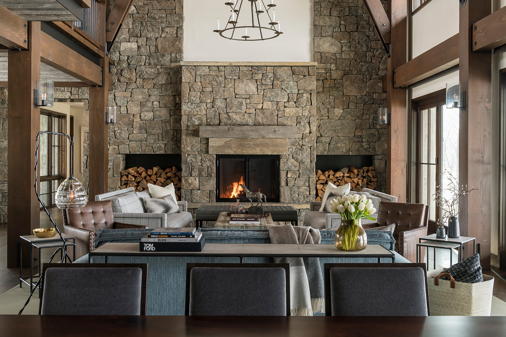 This is an example of a country living room in Other with white walls, a standard fireplace and a stone fireplace surround.