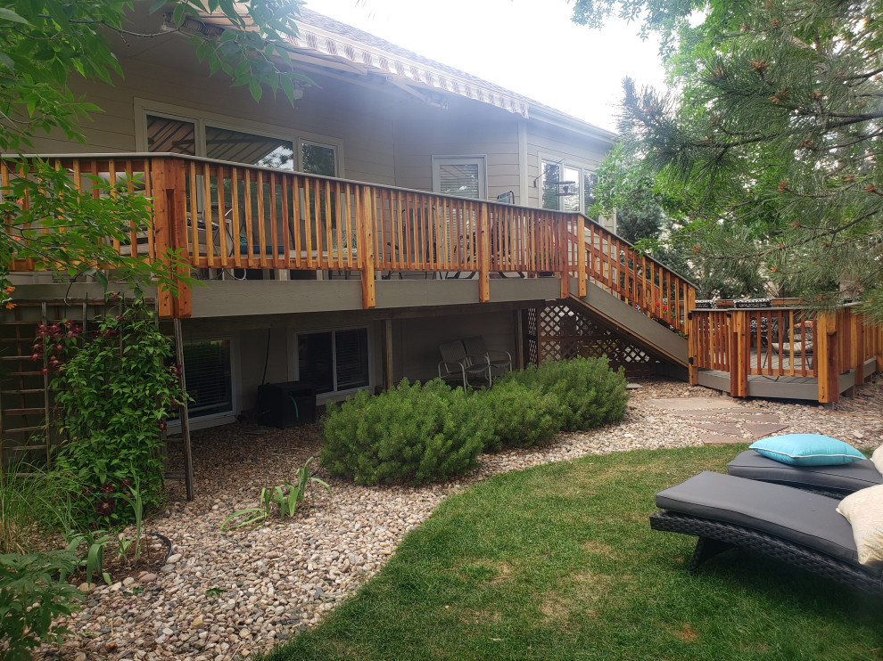 Mid-sized minimalist backyard second story wood railing deck photo in Denver